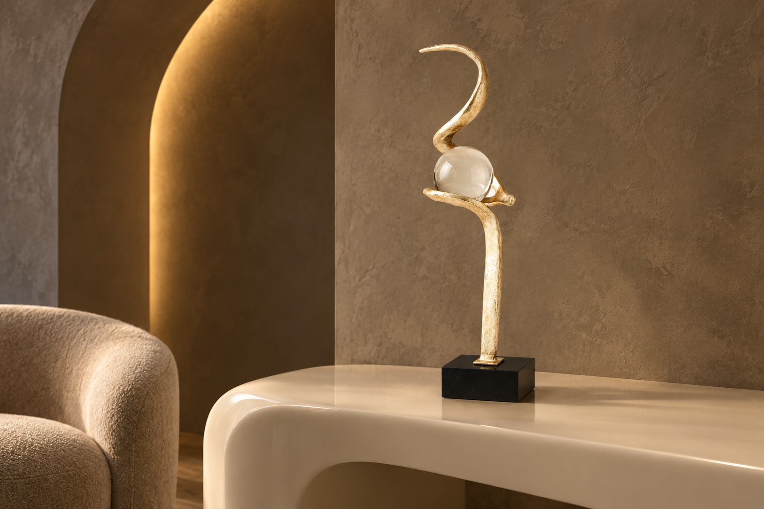 Gold Captured Sphere sculpture styled on a walnut console